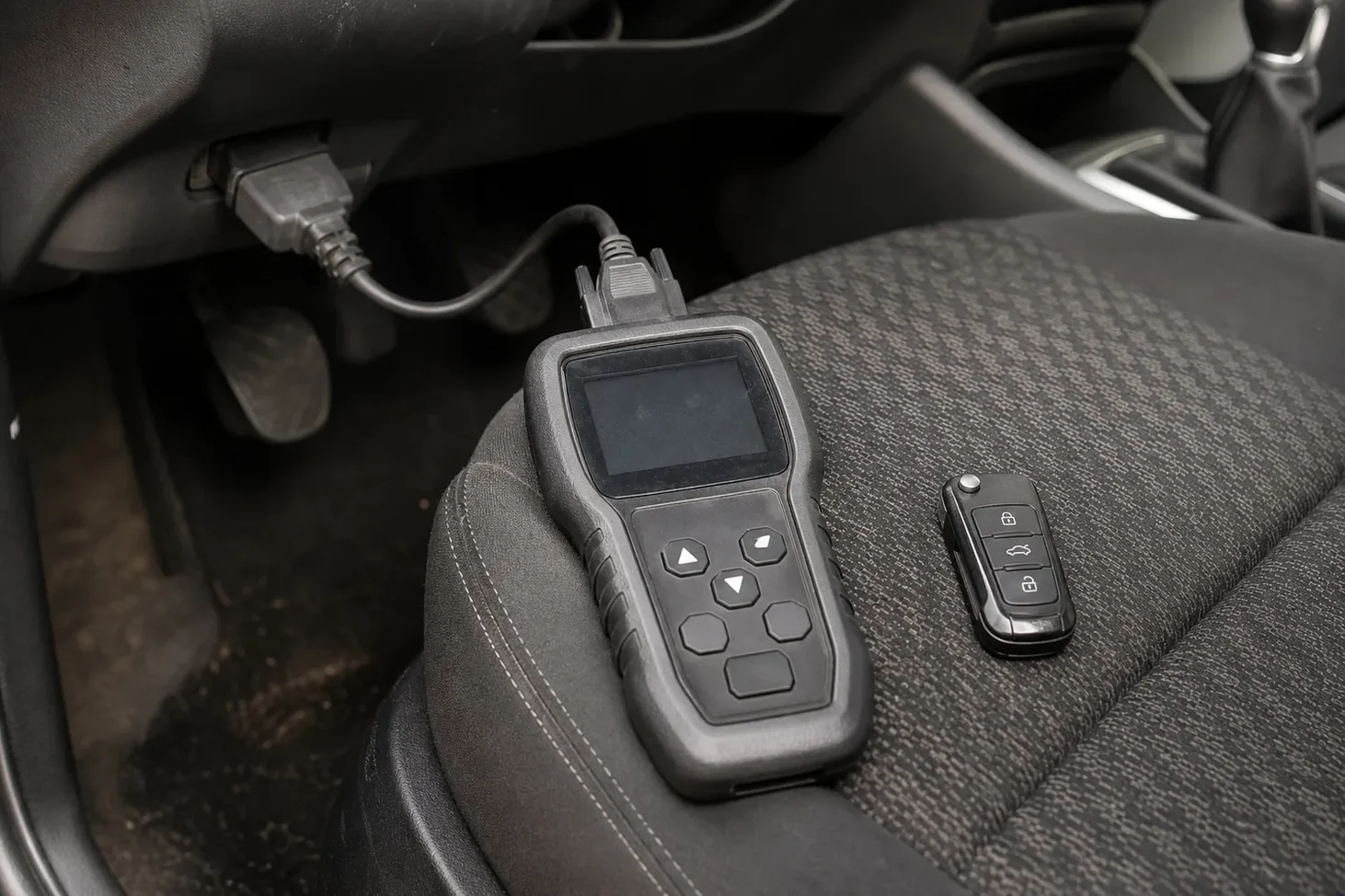 Car key programmer plugged into the OBD port in FL